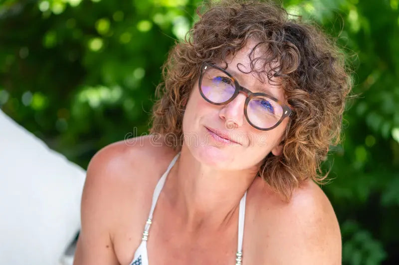 files/elderly-year-old-woman-curly-hair-wearing-glasses-smiles-camera-326997856.webp